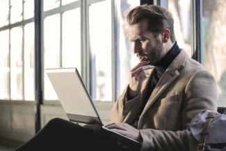 man holding his chin facing laptop computer by bruce mars courtesy of Unsplash.